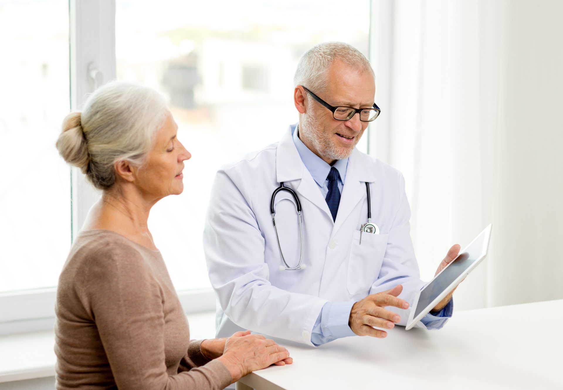 Doctor reviewing remote patient monitoring data with patient